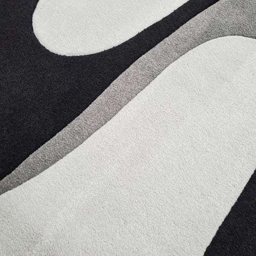 Custom designed rug made with cutting/carving machine and inlayed by hand.