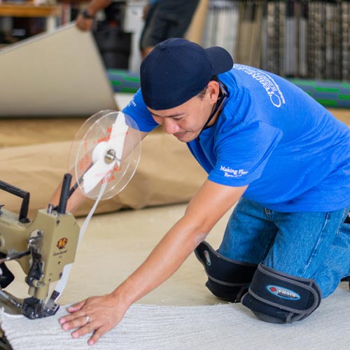 Workers handcrafting custom carpet designs in our large full service workroom.