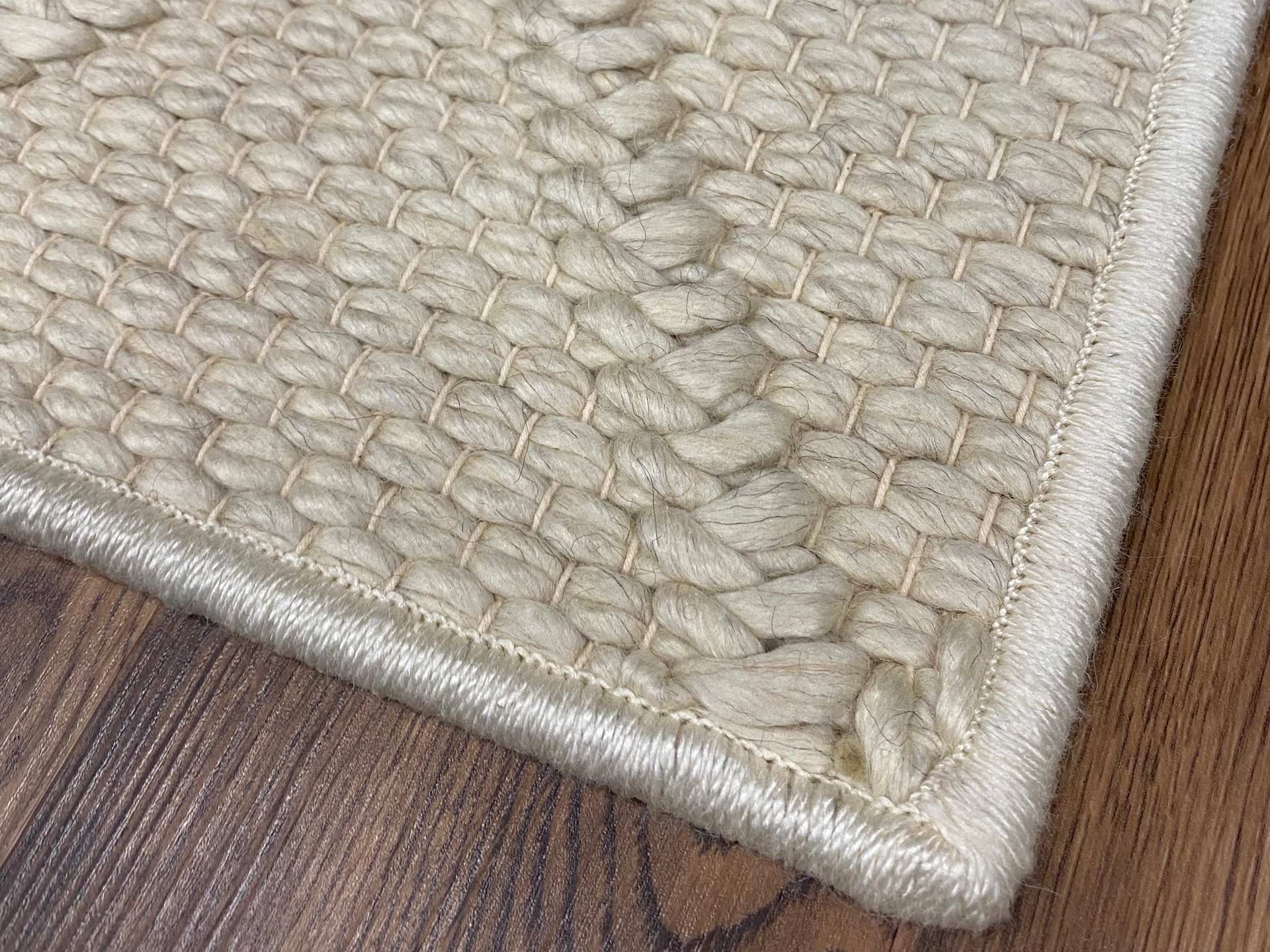 Textured rug with a machine serge edge.